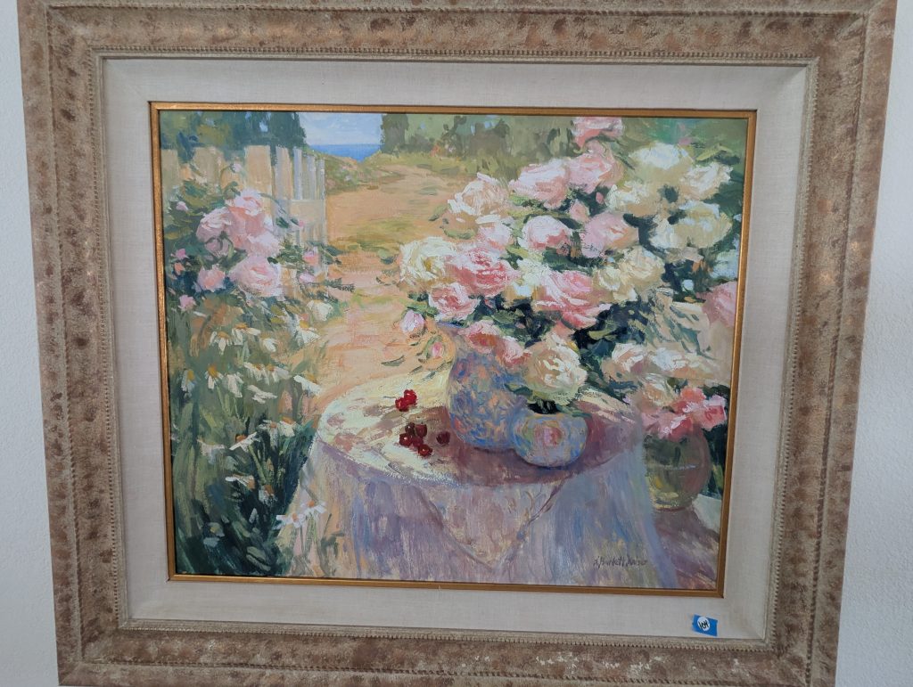 Framed S. Burkett Kaiser “Roses in the Garden” painting showing pink and white roses beside a garden path.