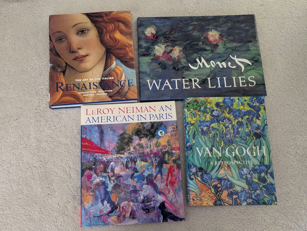 Four art books featuring Italian Renaissance art, Monet’s Water Lilies, LeRoy Neiman’s An American in Paris and Van Gogh.