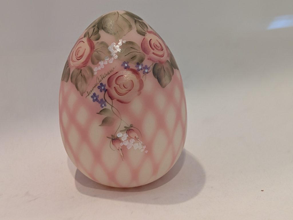 Fenton Burmese Diamond Optic glass egg with pink shading, painted roses and small purple flowers.
