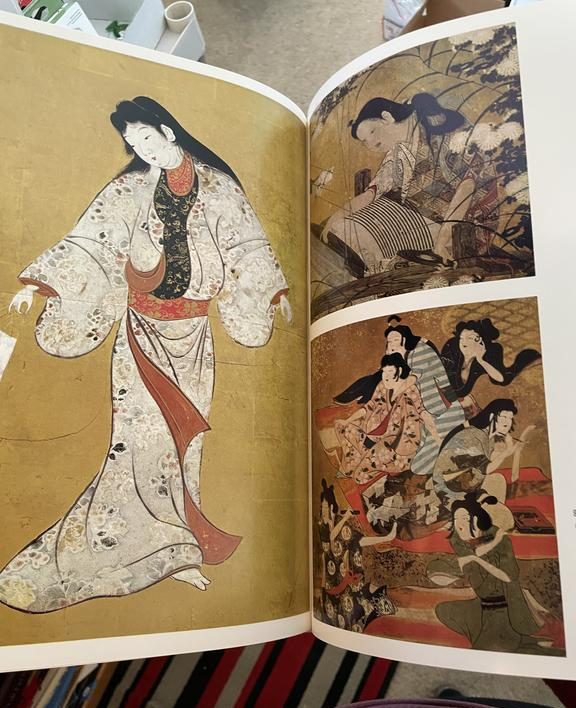 Open Japanese art book displaying traditional screen paintings