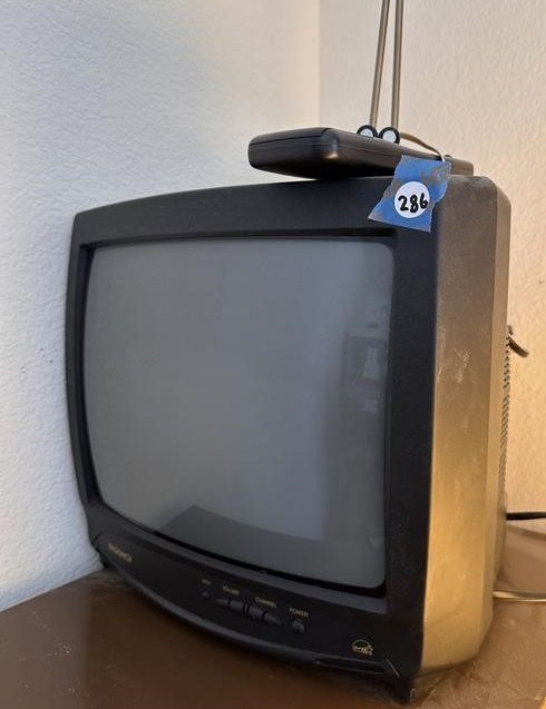 Vintage portable television with antenna and remote control