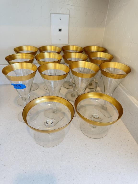 Lot 133: Dorothy Thorpe clear glass stemware with wide gold bands around the rims.