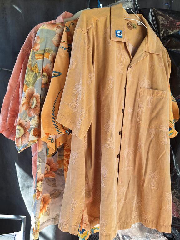 Four Tommy Bahama short-sleeve shirts in warm colors and tropical patterns in the Burlwood and Collectibles Auction.